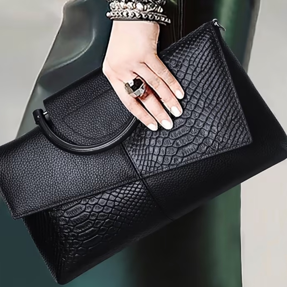 Luce black asnakeskin clutch bag